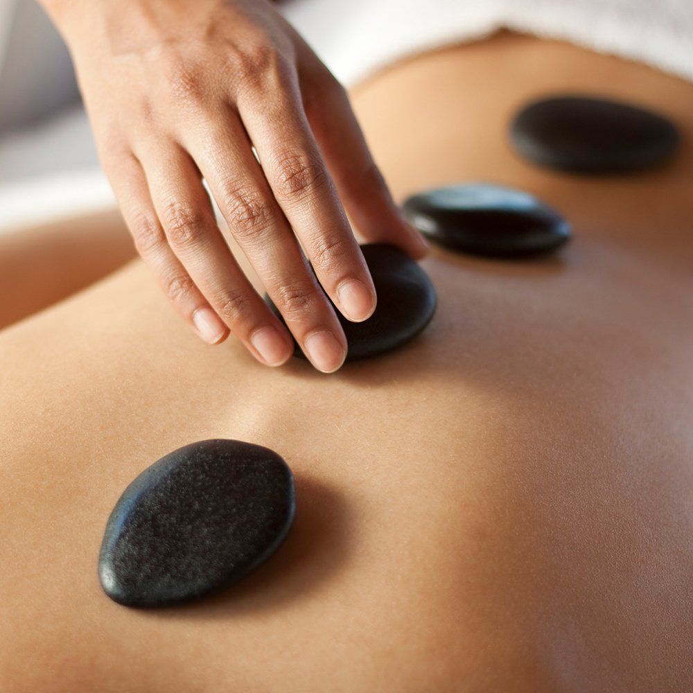 Using Stone For Massage — Great Neck, NY — Butterfly Garden Spa