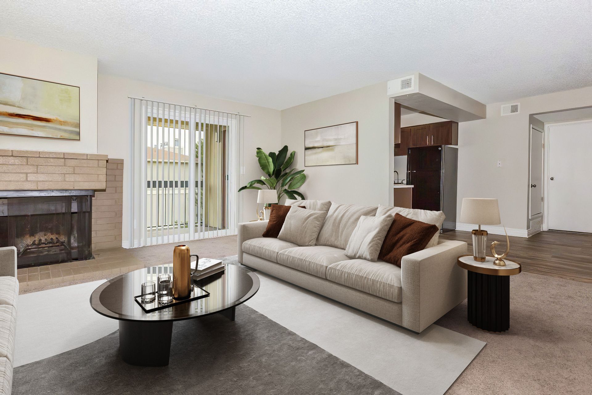 Cozy living room with fireplace, balcony, neutral colors, sofa, coffee table, and lamp.
