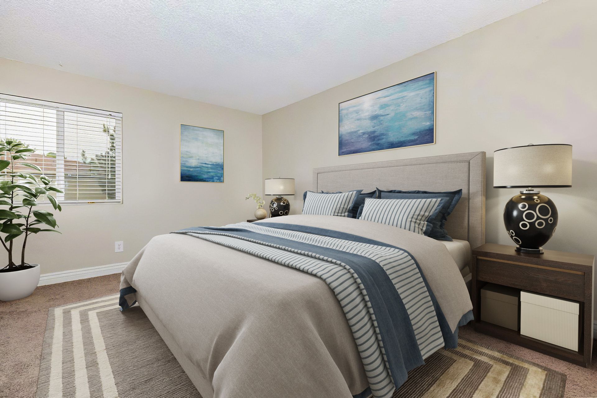 Bedroom with bed, art, bedside table, rug, and window with blinds.