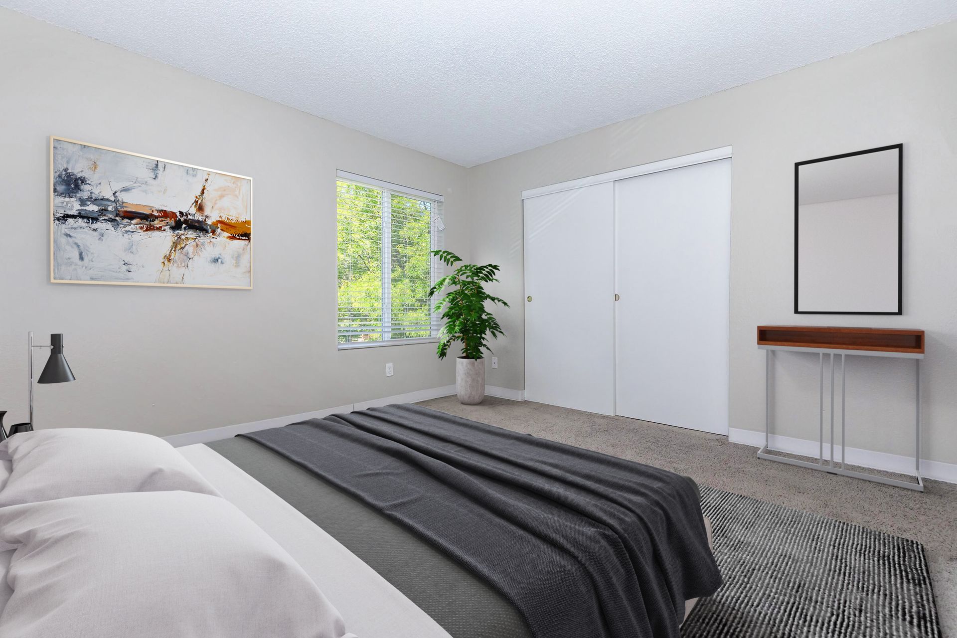 Bedroom with a bed, artwork, large window, closet, and console table with mirror.