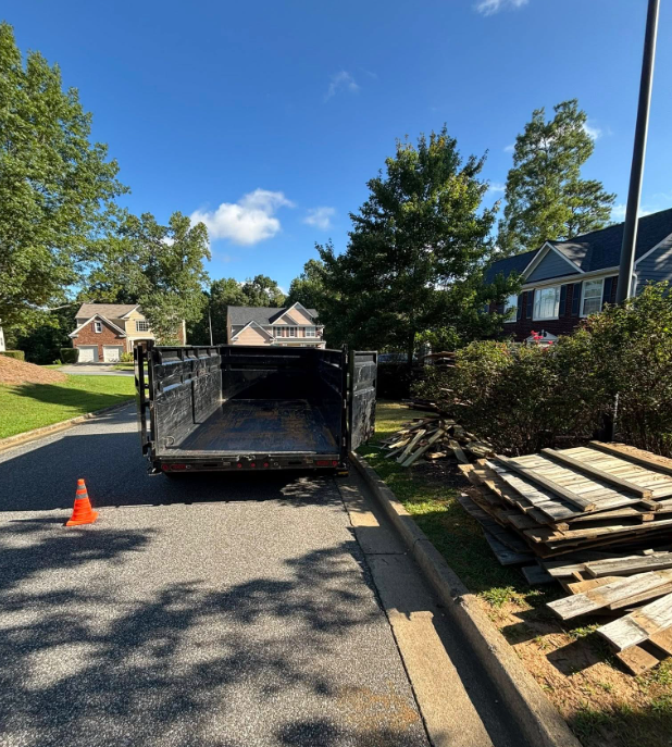Dumpster overflowing with construction debris outside a building.