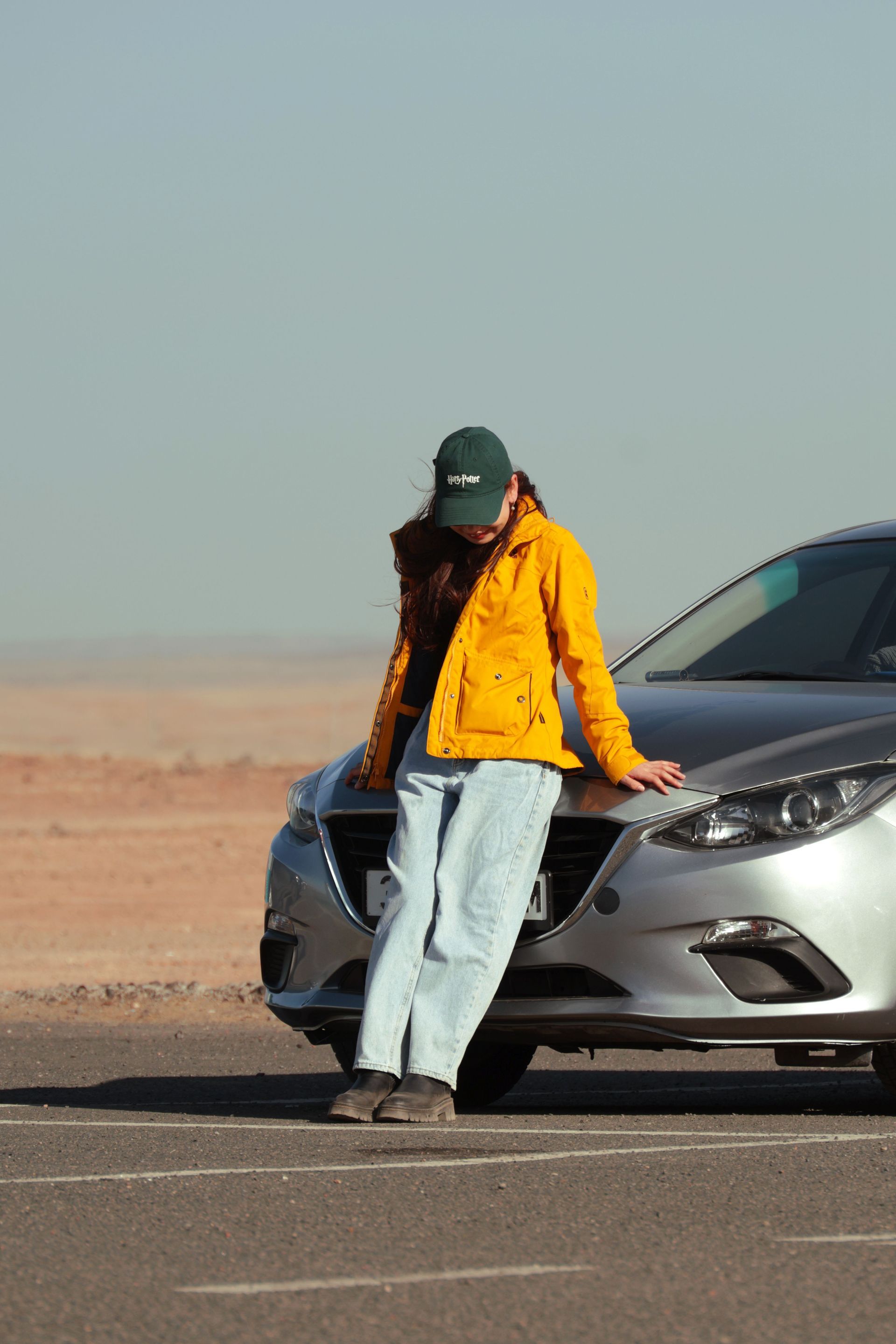 A man is holding a red gas can next to a car.