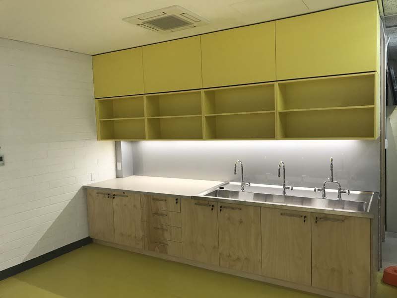yellow cabinets above sinks