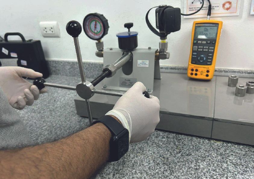 Las manos operan un dispositivo de prueba de presión con medidores,