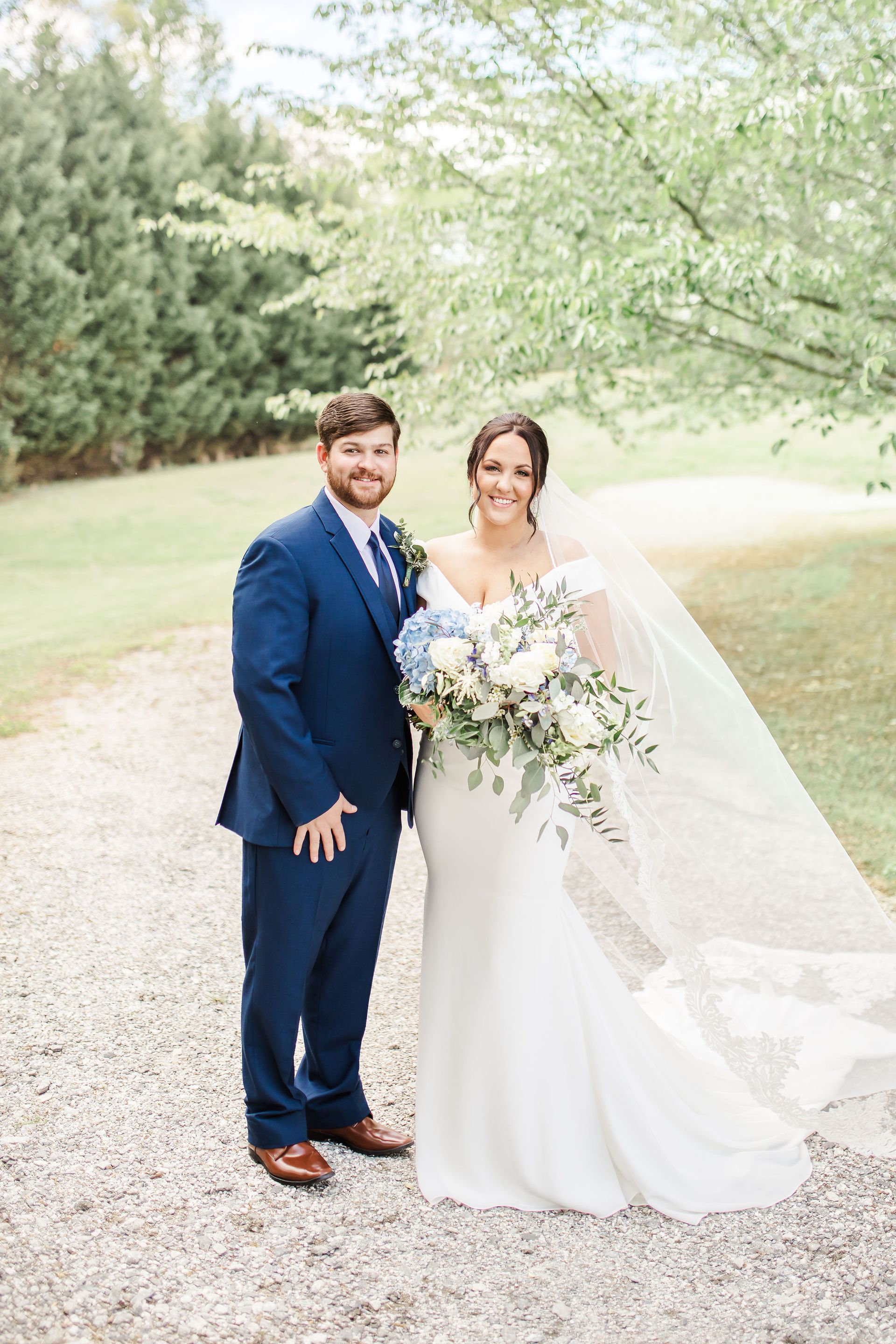A bride and groom are posing for a picture on their wedding day.