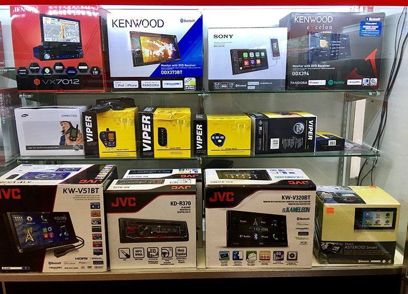 A display case filled with a variety of car radios.