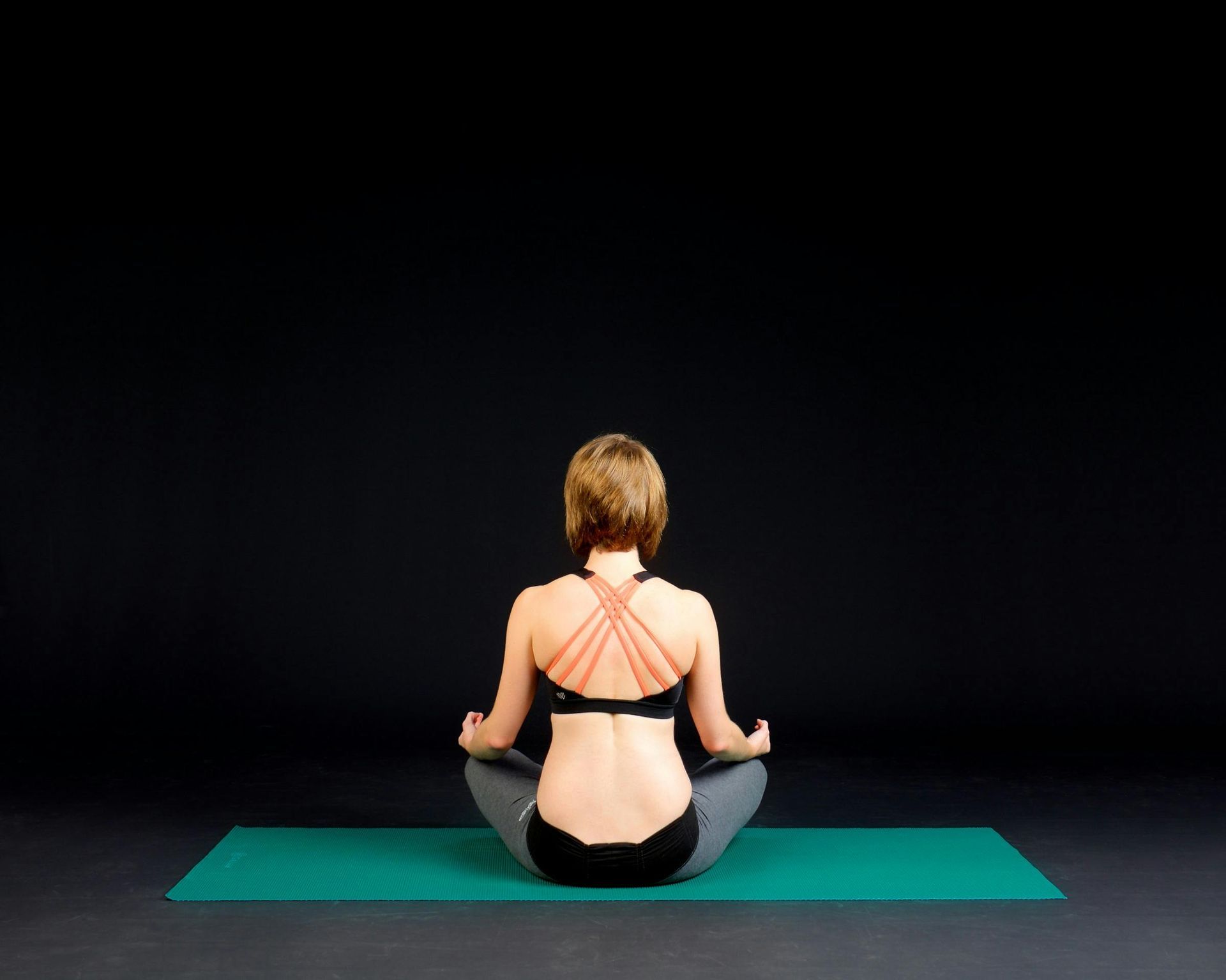 Lady meditating on a yoga mat