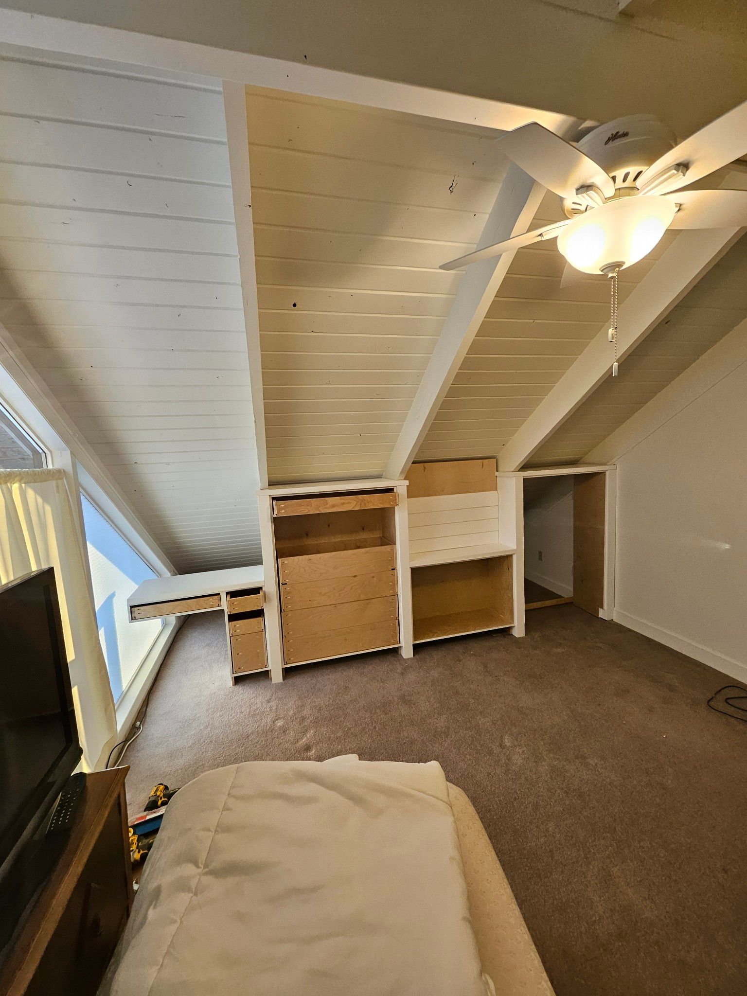 A living room with a ceiling fan and a couch.