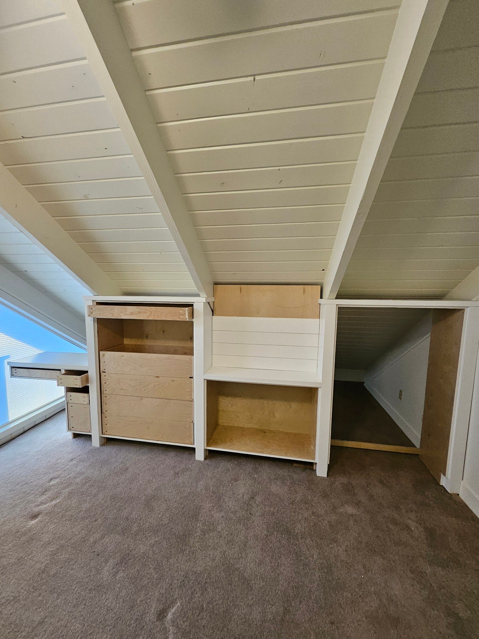 A room with a white ceiling and wooden shelves
