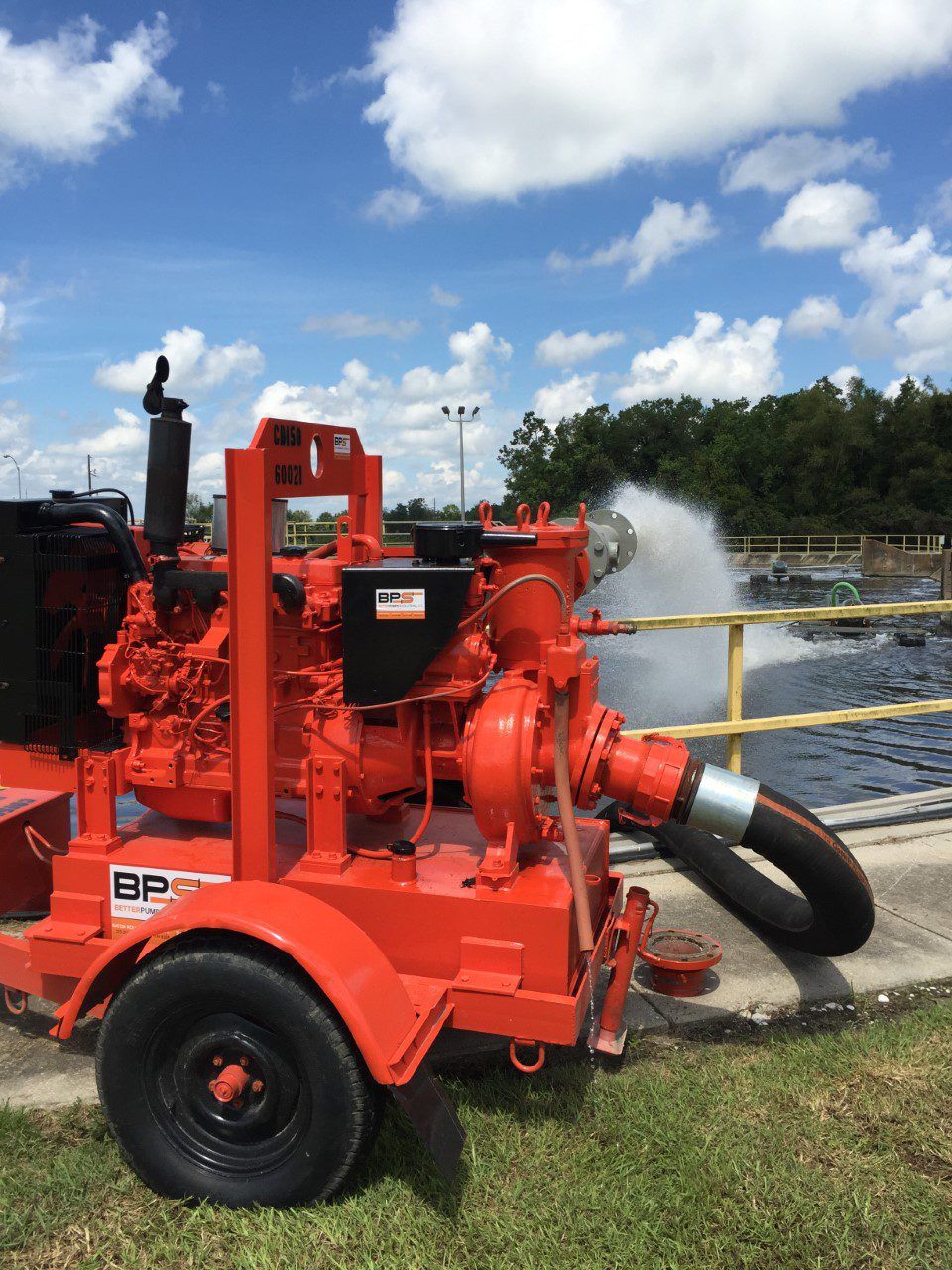 A person in a white apron is working in a kitchen