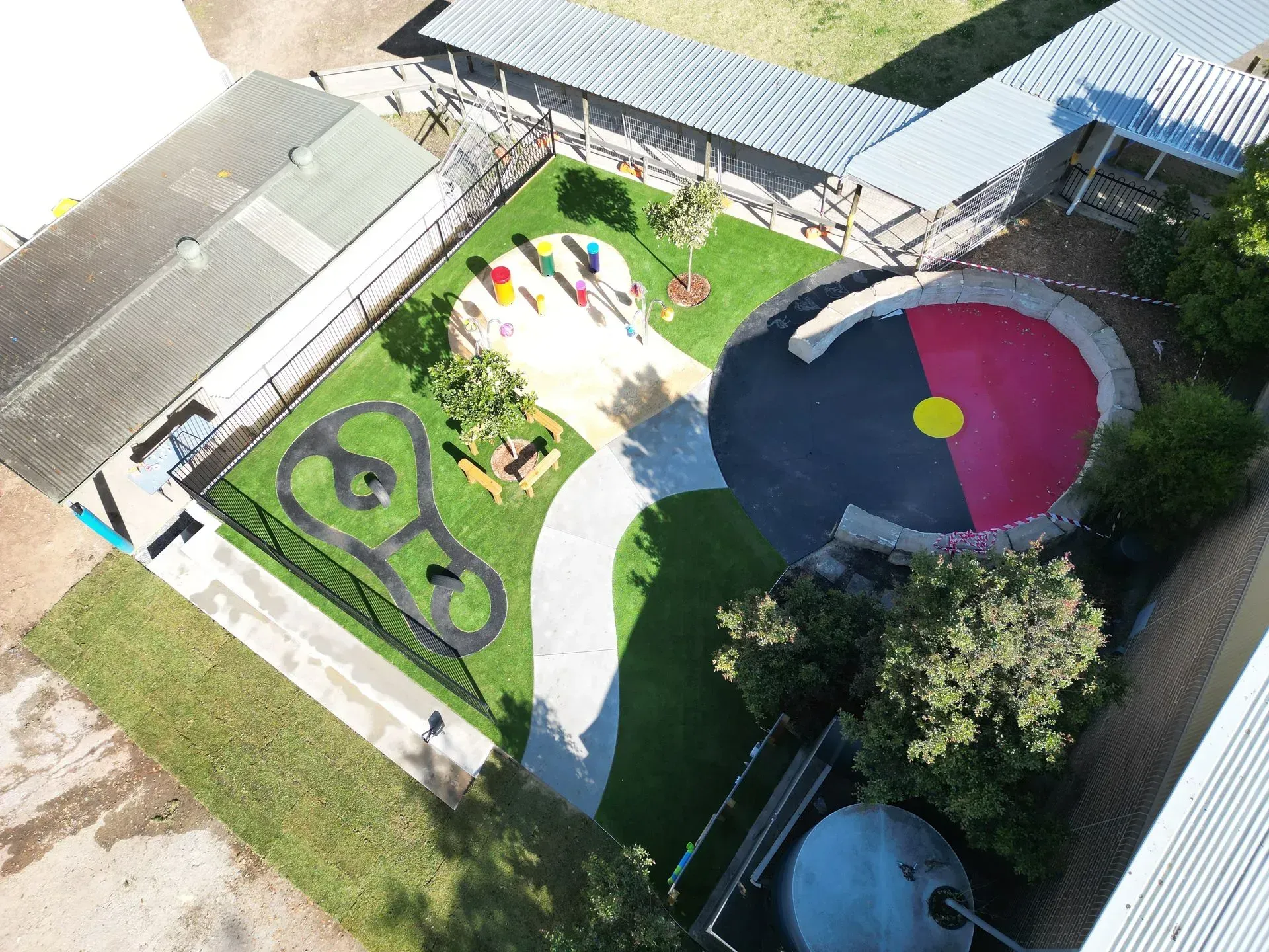 Aerial view of a school playground with Aboriginal flag colors incorporated in design.