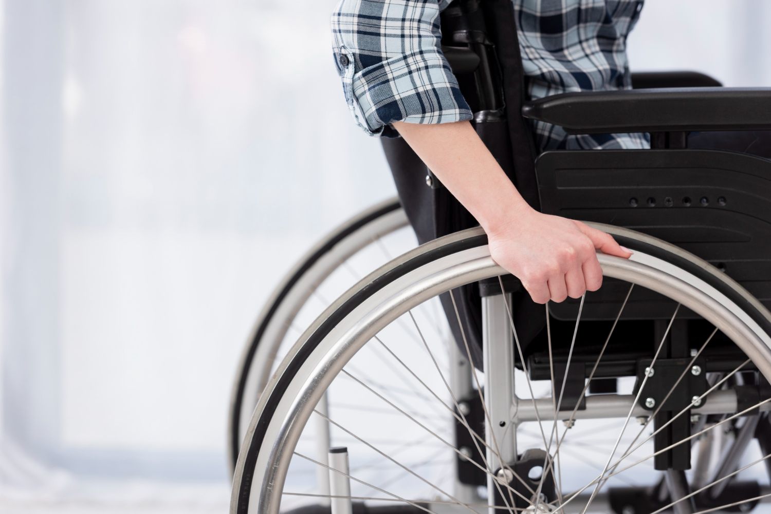 A person in a wheelchair is holding the wheel.