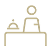 A person is sitting at a table with a tray on it.