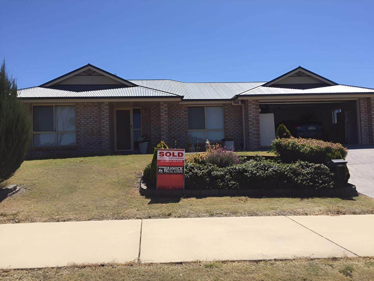 A House With A Sold Sign In Front Of It — Grant Finance Solutions In Toowoomba, QLD