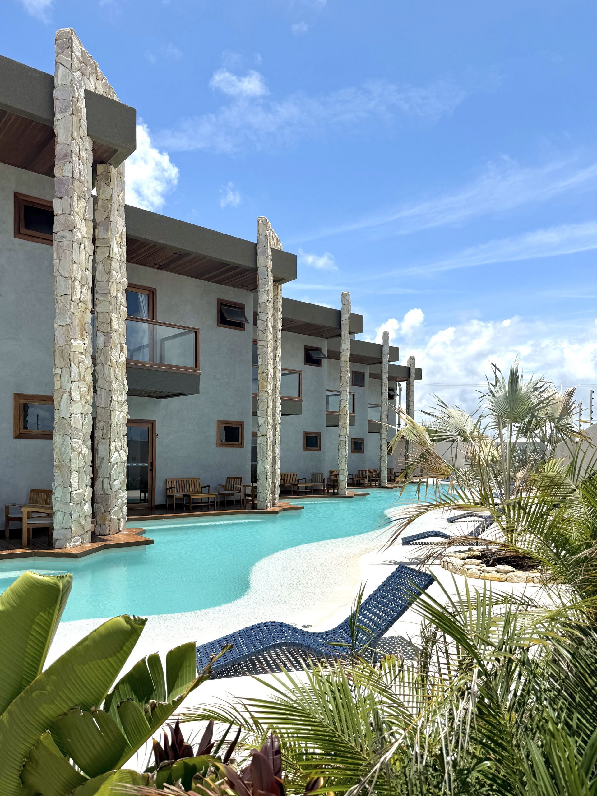 Há uma grande piscina em frente a um prédio.