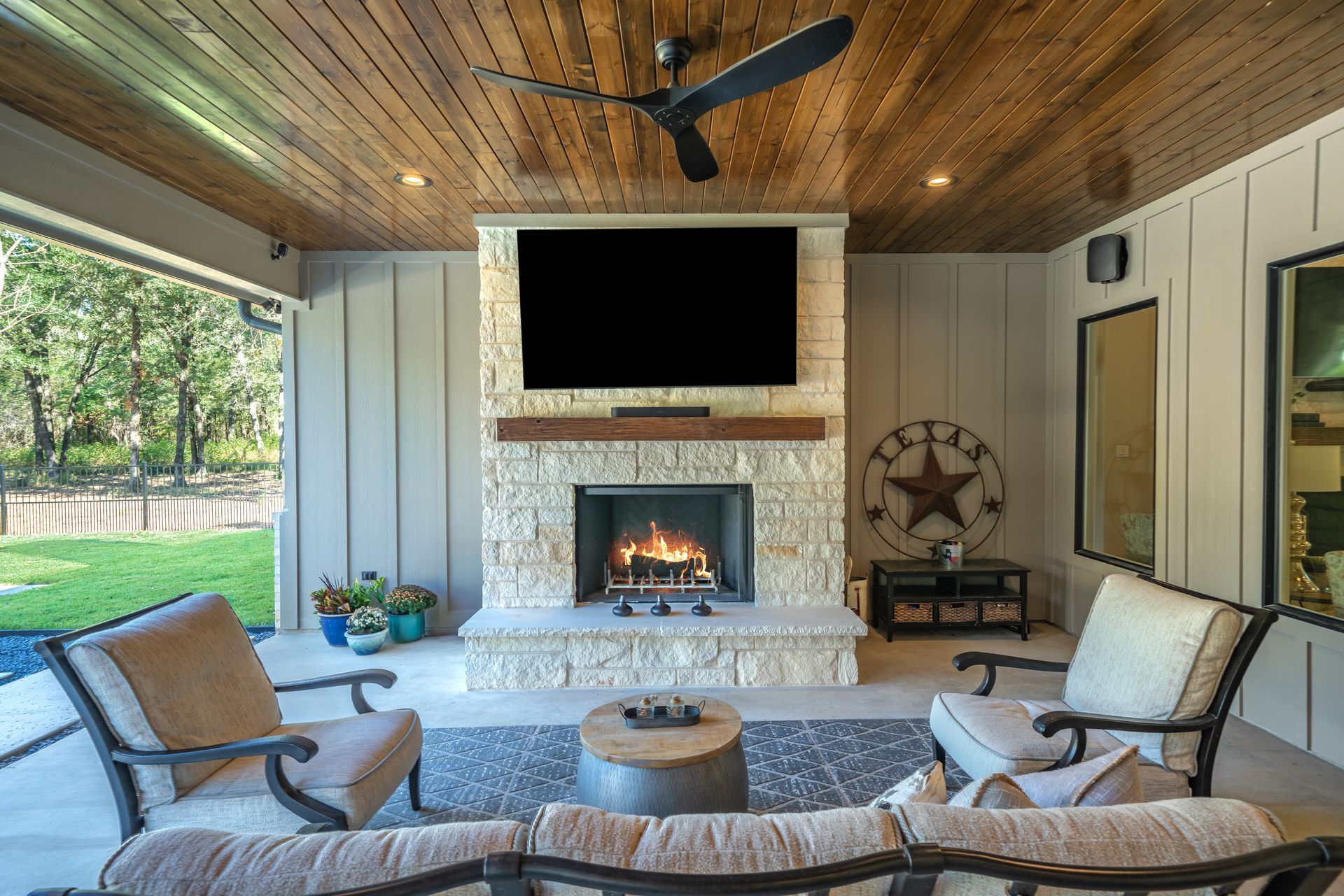 A living room with a fireplace and a flat screen tv.