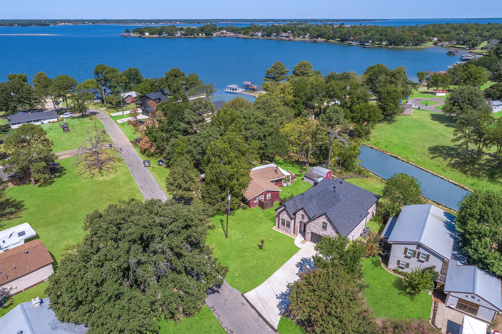 An aerial view of a residential area next to a body of water.