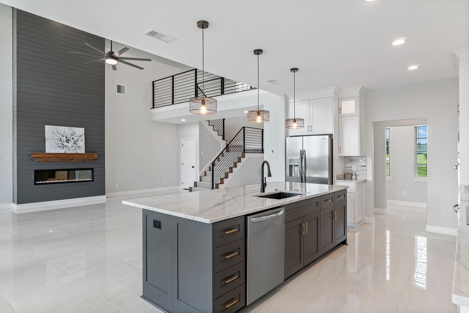 A kitchen with a large island and stainless steel appliances.