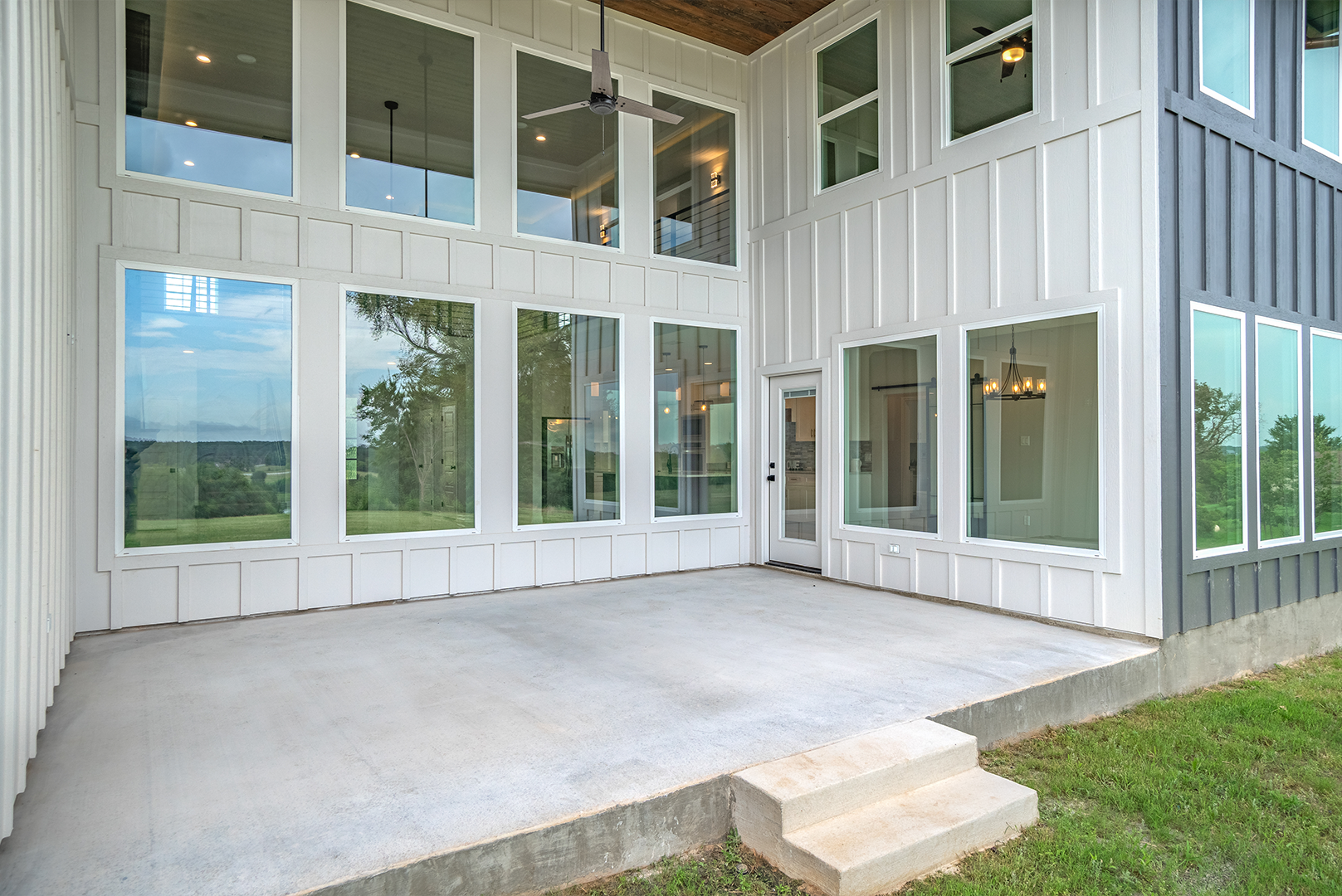 A large house with a lot of windows and a patio.