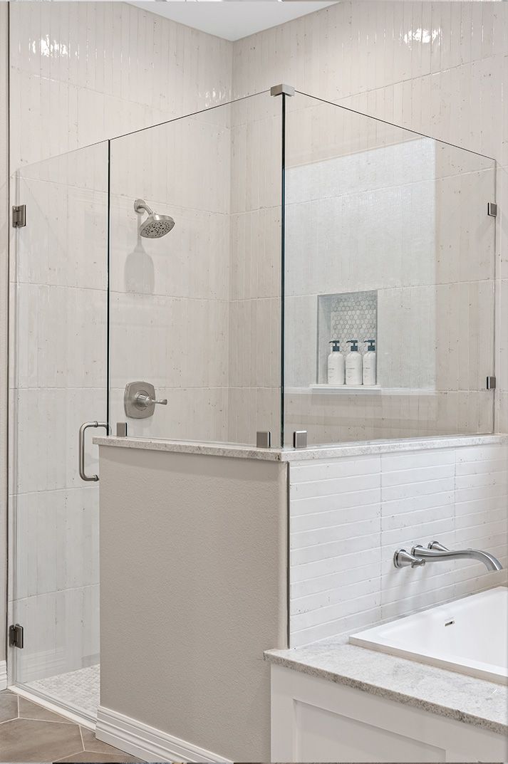 A bathroom with a walk in shower and a bathtub.