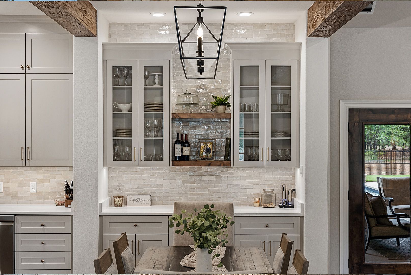 A kitchen with a dining room table and chairs and a bar.
