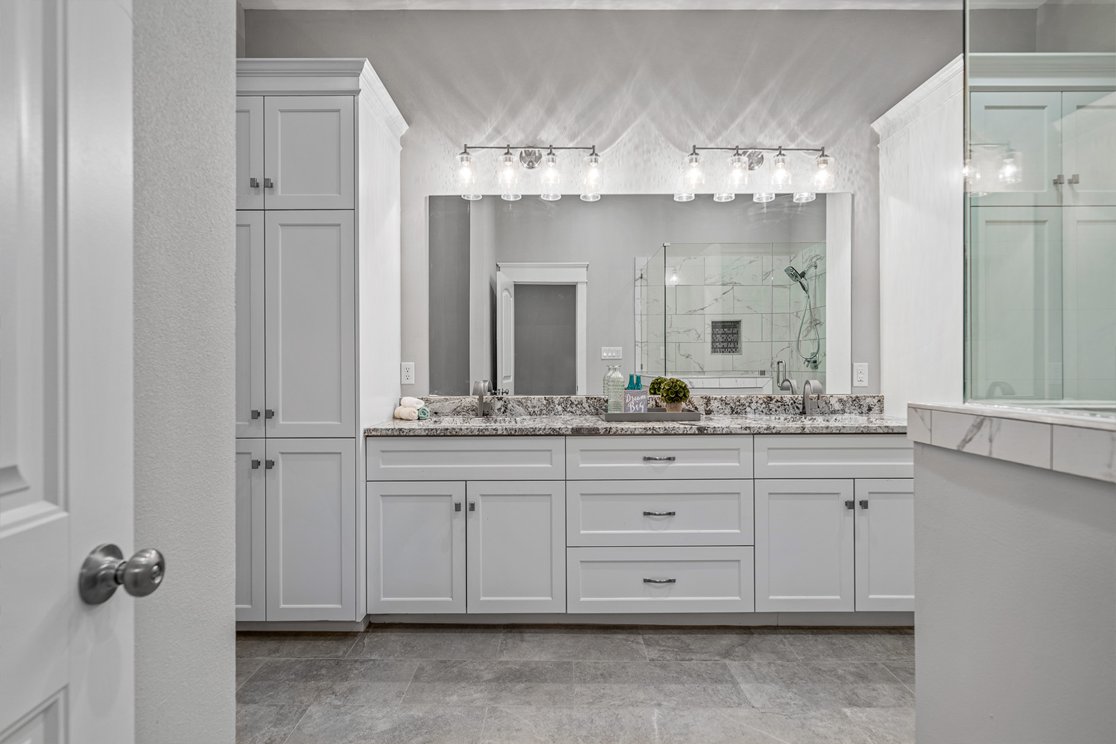 A bathroom with two sinks and a large mirror.