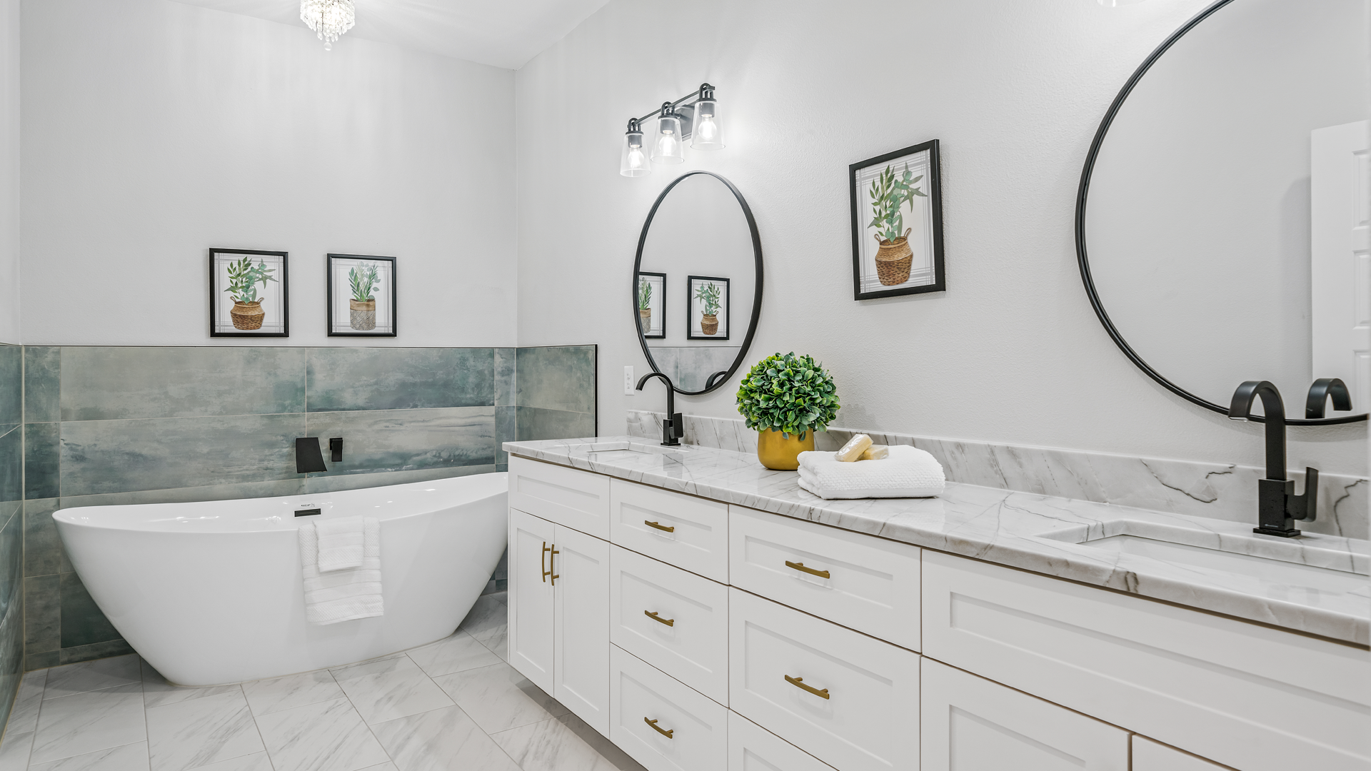 A bathroom with two sinks , a tub , and two mirrors.