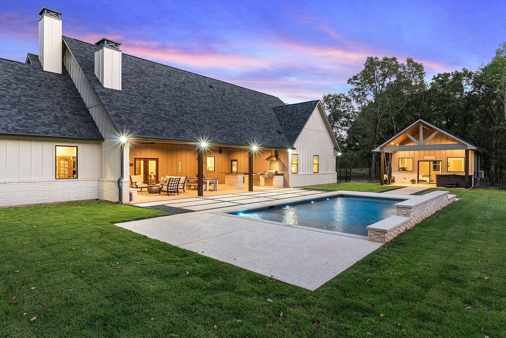 A large house with a large swimming pool in the backyard.