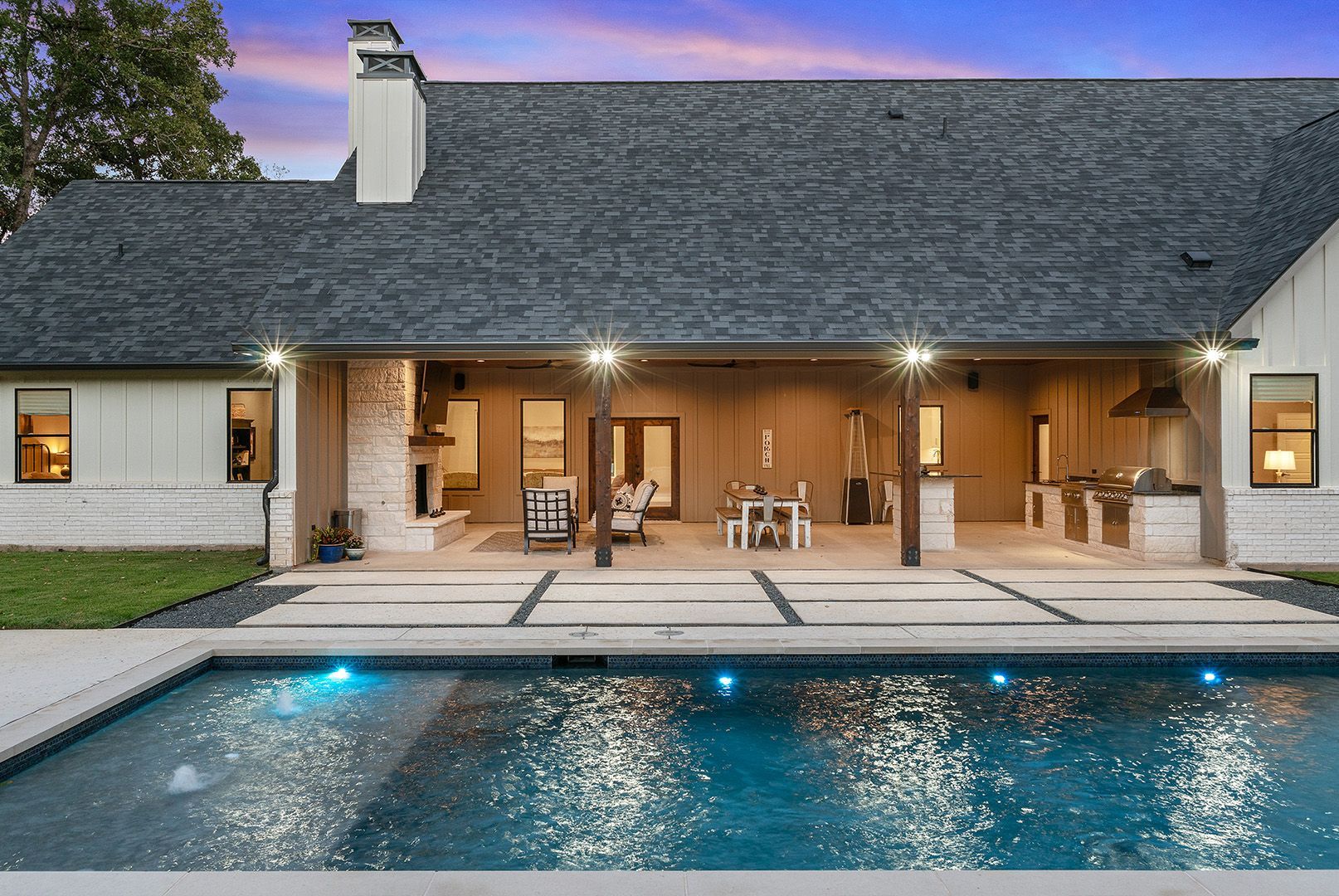 A house with a large swimming pool in front of it