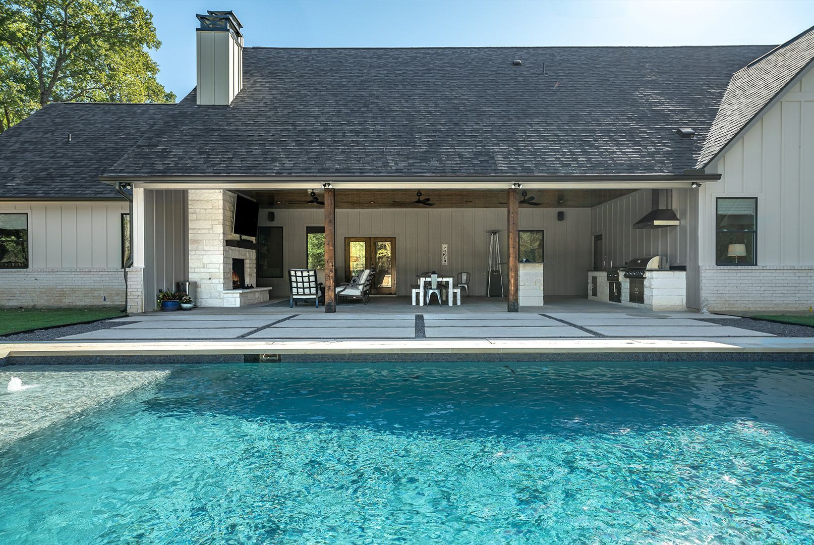 A large house with a swimming pool in front of it.