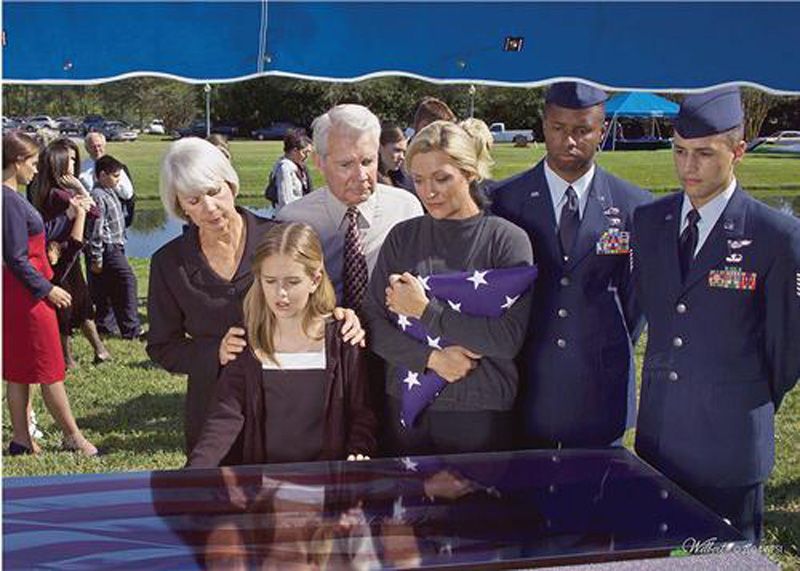 a group of people standing around a coffin with a flag on it