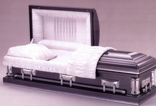 a black coffin with the lid open and white sheets