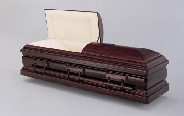 a wooden coffin with the lid open on a gray background