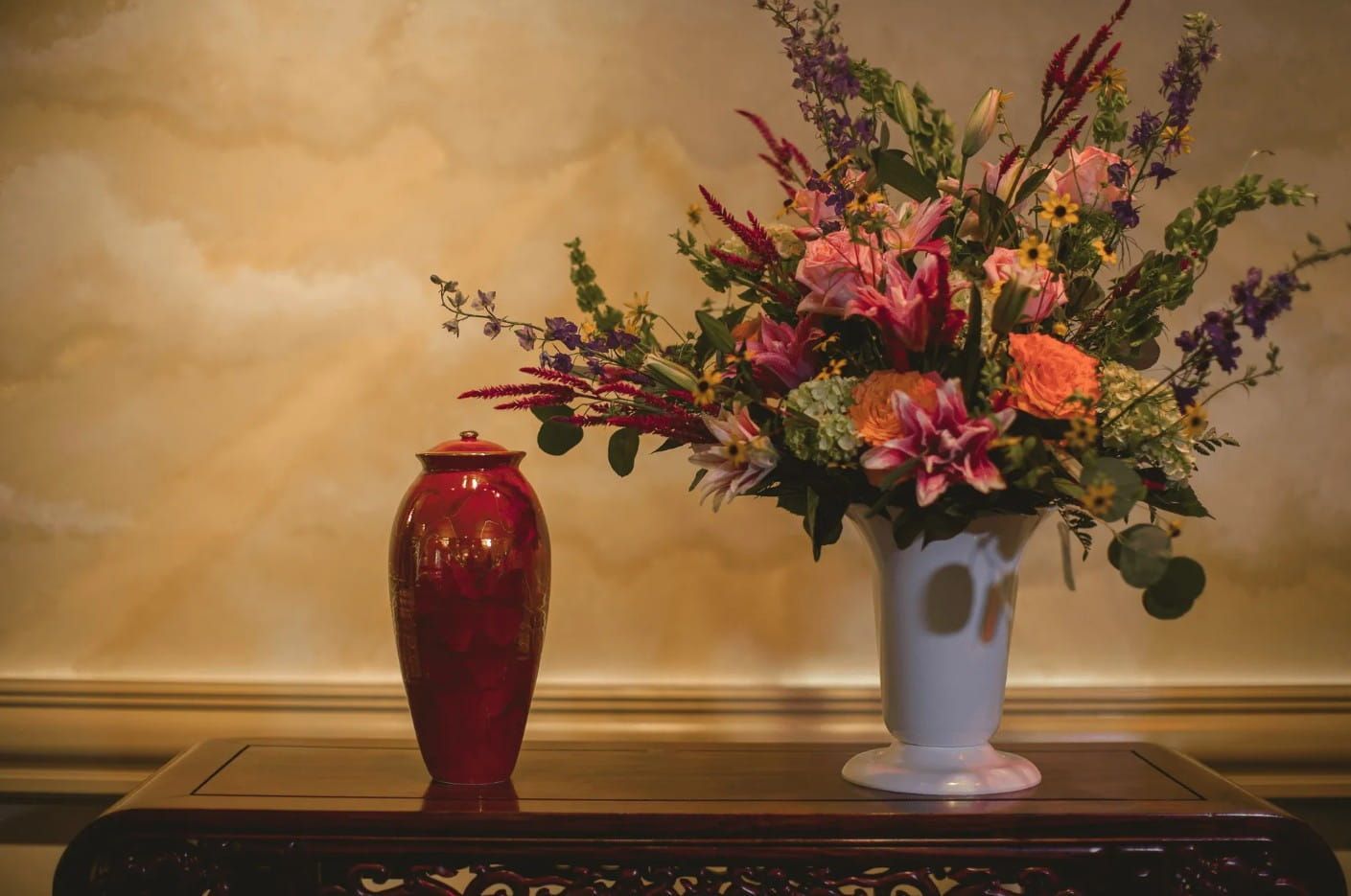 Decorative urn and floral arrangement displayed for funeral and cremation services in Indianapolis, IN