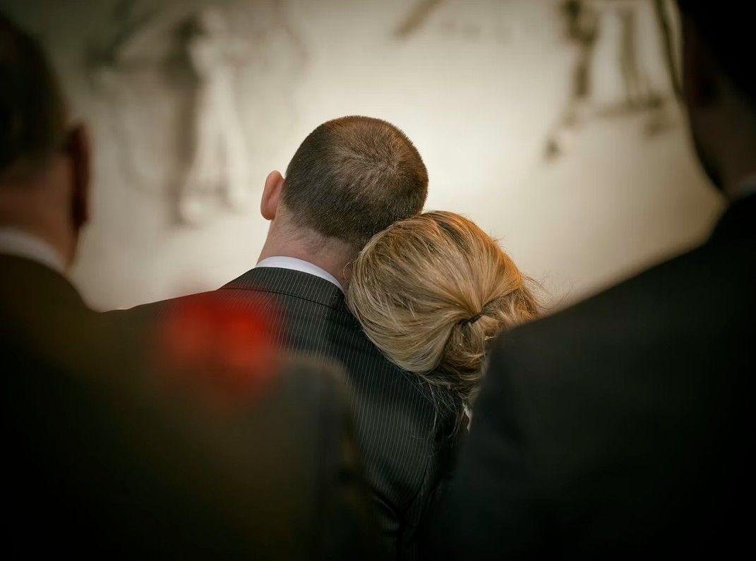 Family members sharing a quiet moment during a memorial service, reflecting trusted support for funeral and cremation in Zionsville, IN