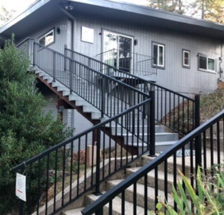 A balcony with a stainless steel railing and clear glass