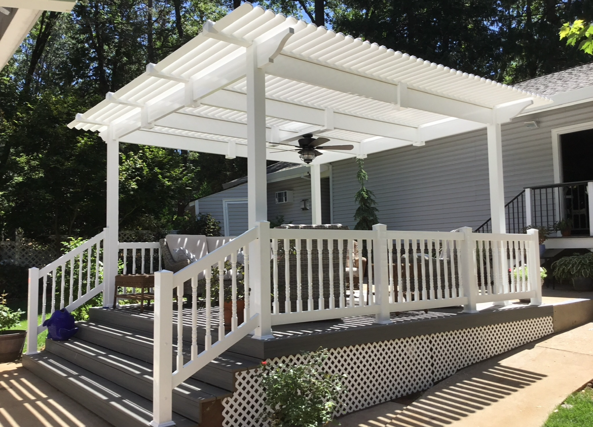A glass railing with a stainless steel railing on a walkway