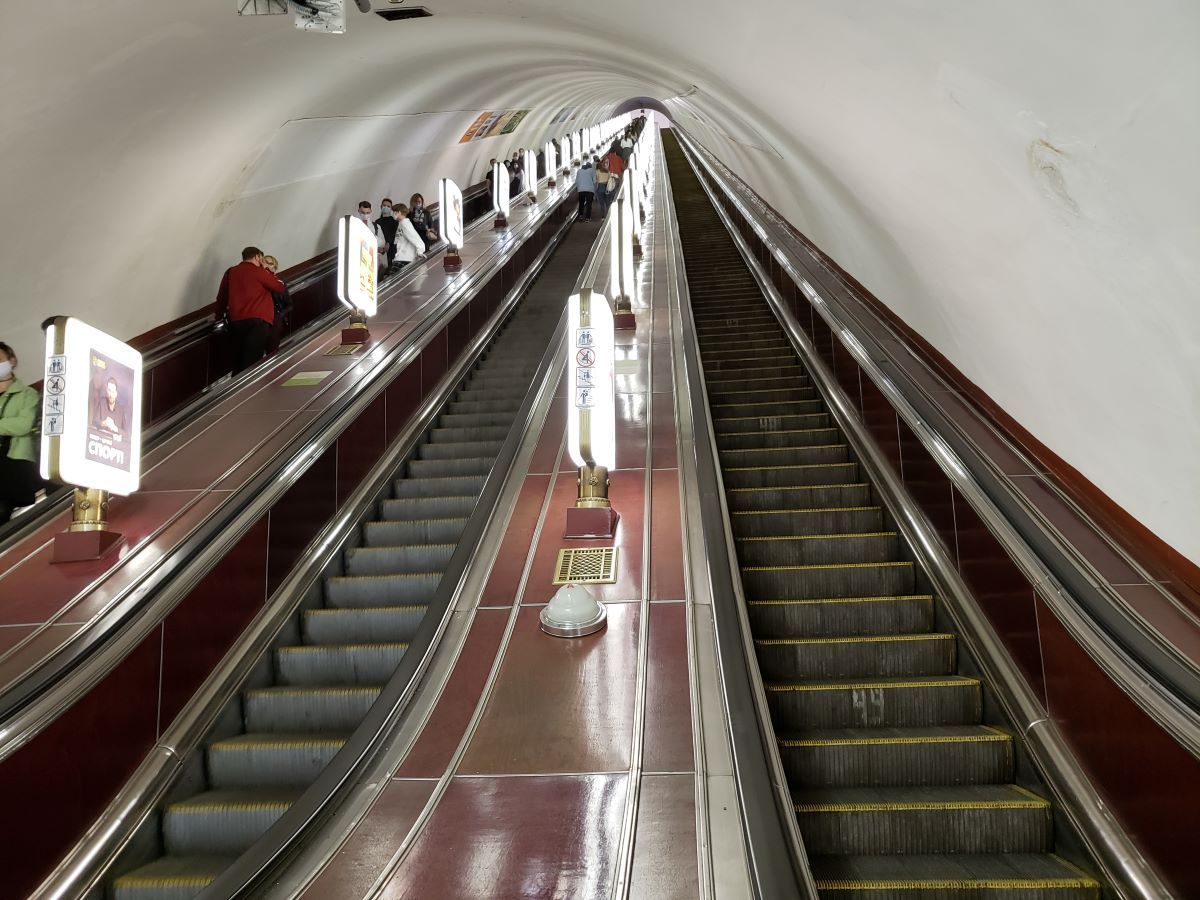 People riding escalator