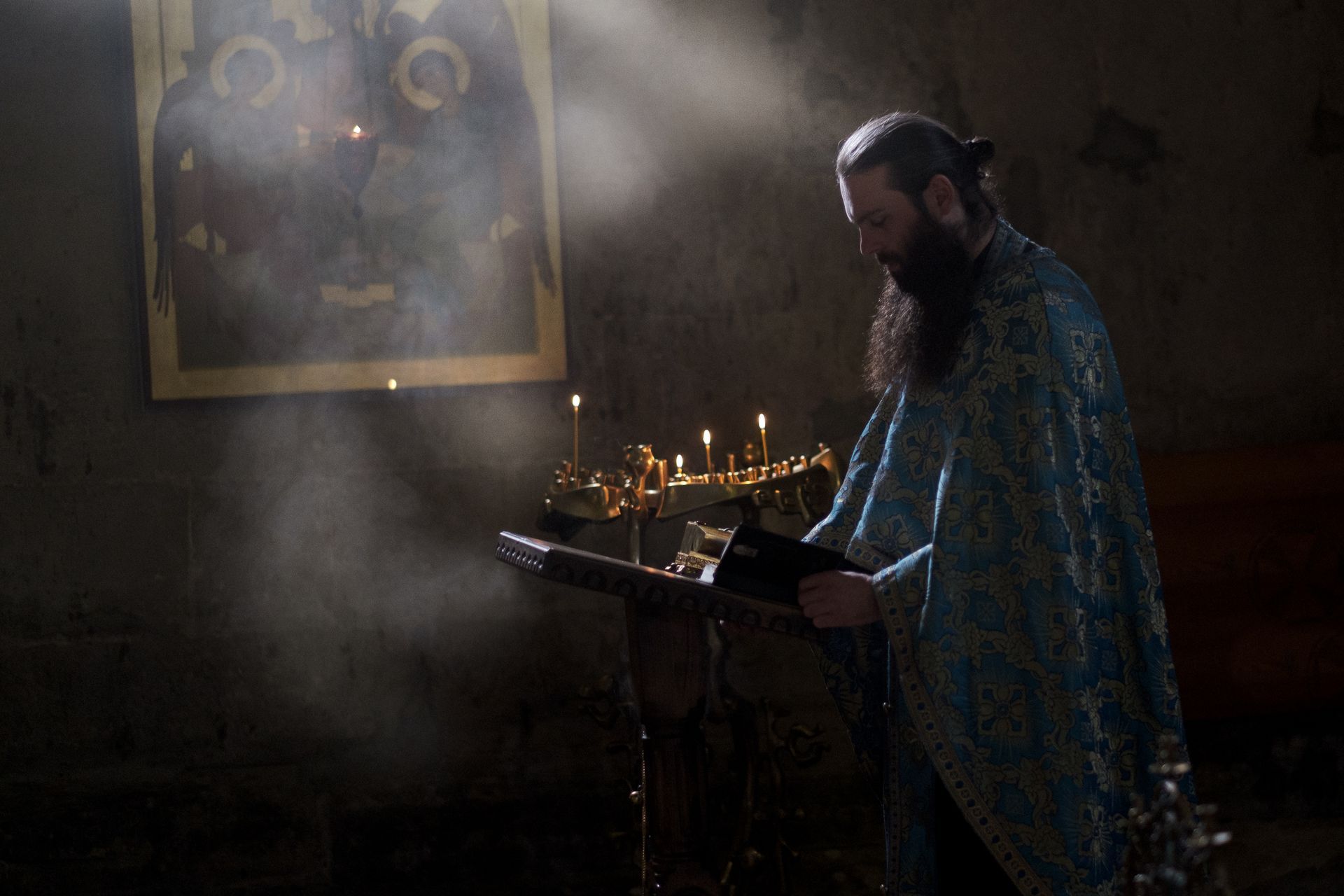 Man praying in at a podium in a church