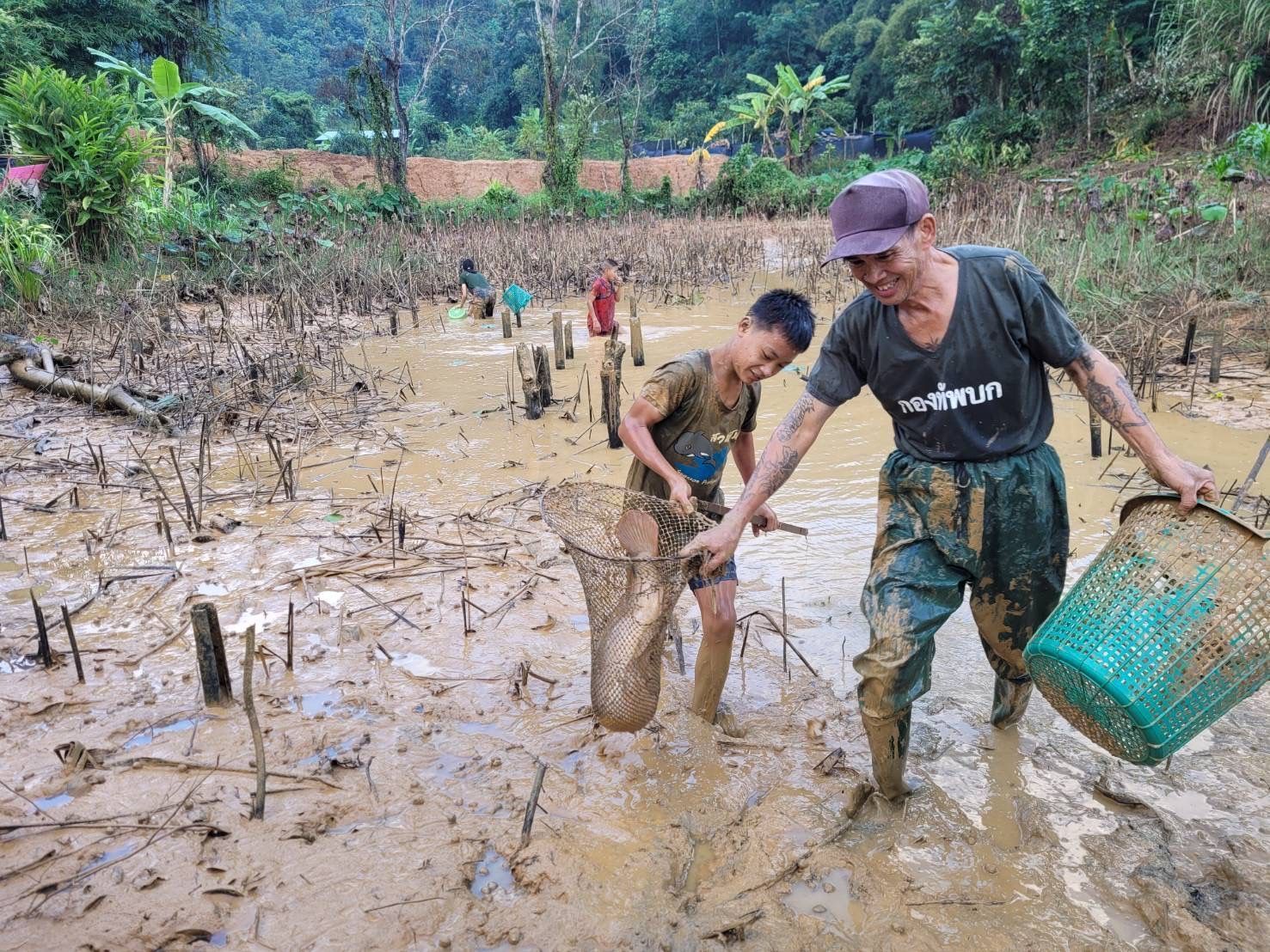 Man and boy catching a fish in a net