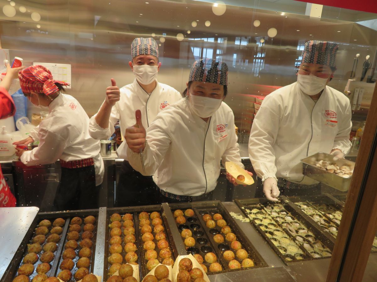 Men making octopus balls in a mall