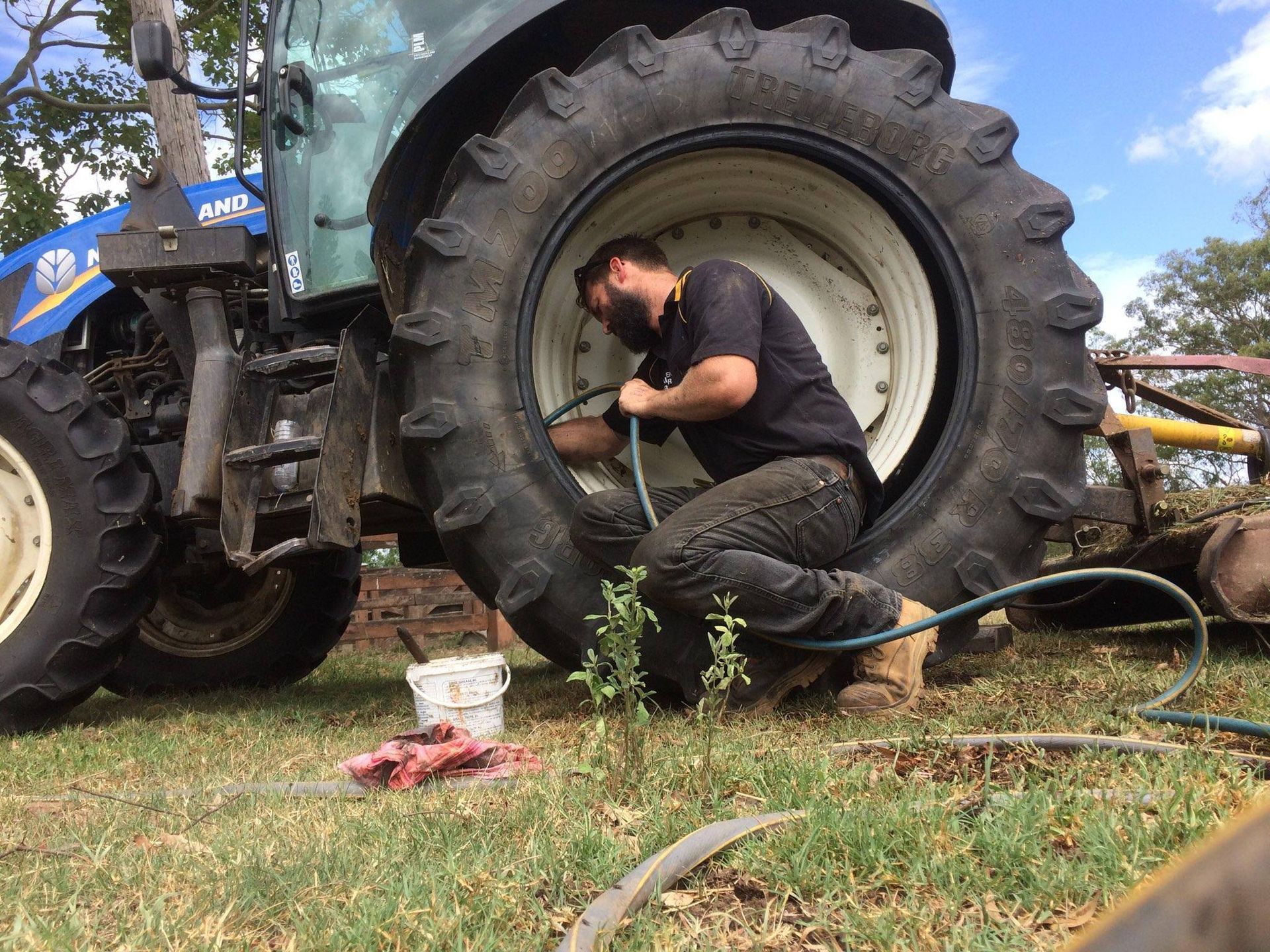 Man Working on a Tractor Tyre — Beaudesert, QLD — Beaudesert Tyre Store