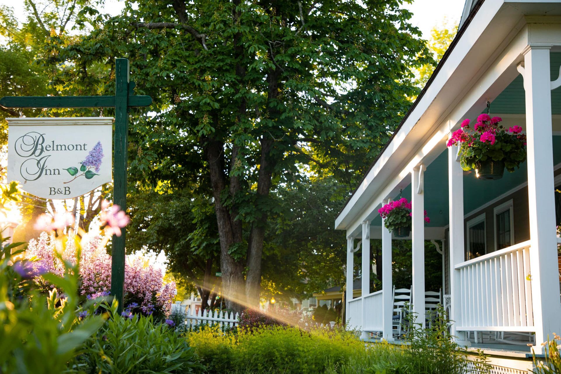 A house with a porch and a sign that says beloved