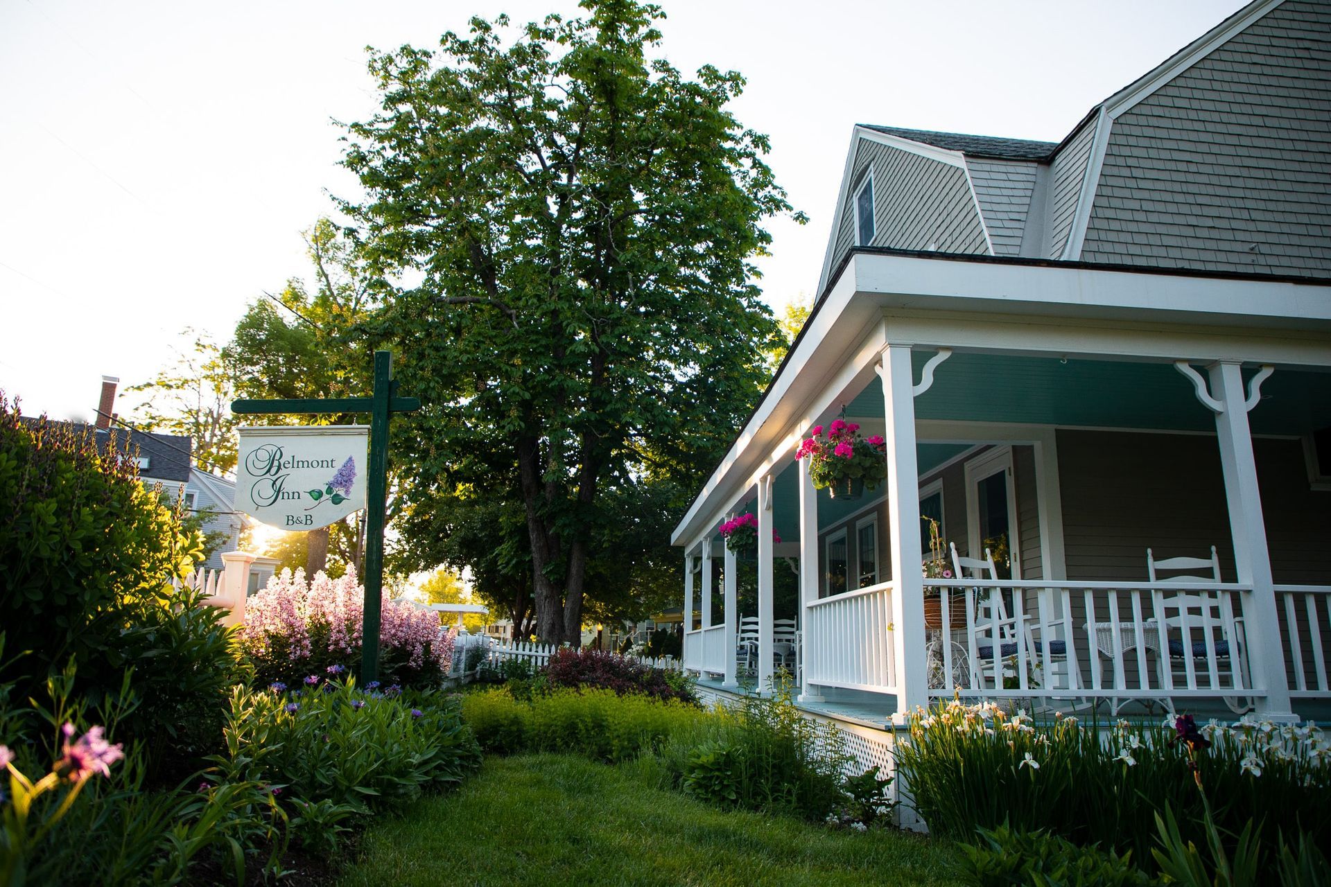 A house with a porch and a sign that says ' a ' on it