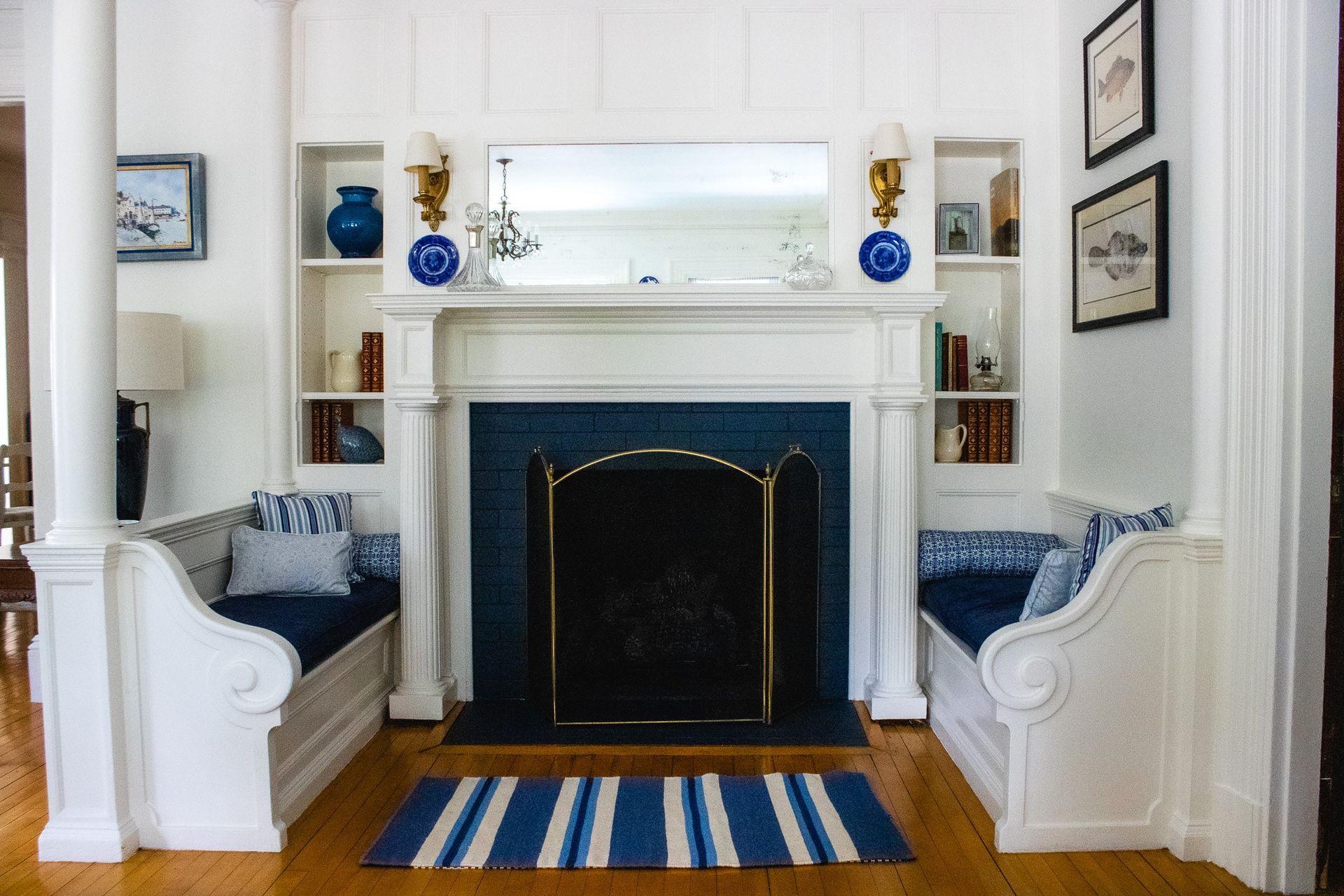 A living room with a fireplace , benches and a rug.