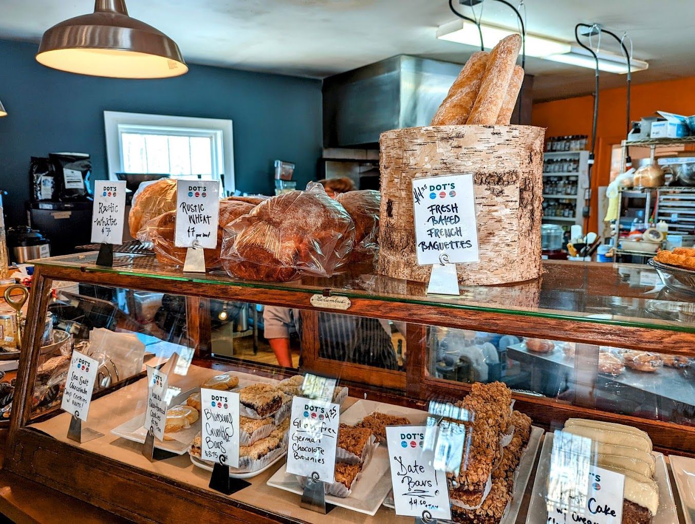 A display case filled with bread and pastries in a bakery.