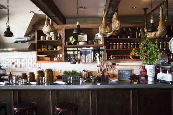 A kitchen with a bar and stools in it