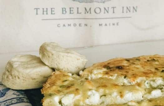 A close up of a pie and biscuits in front of a sign that says the belmont inn