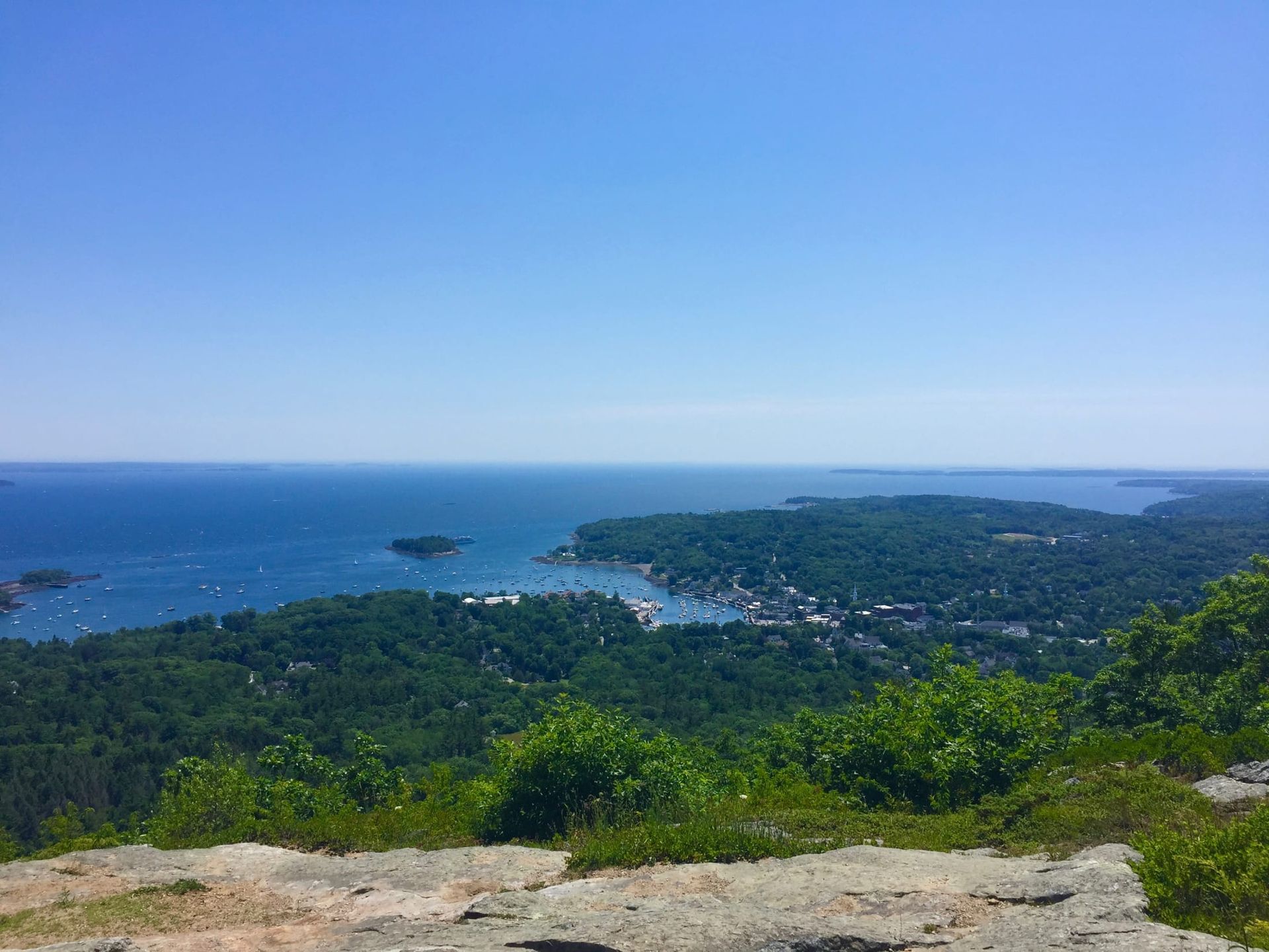 A view of the ocean from the top of a mountain.