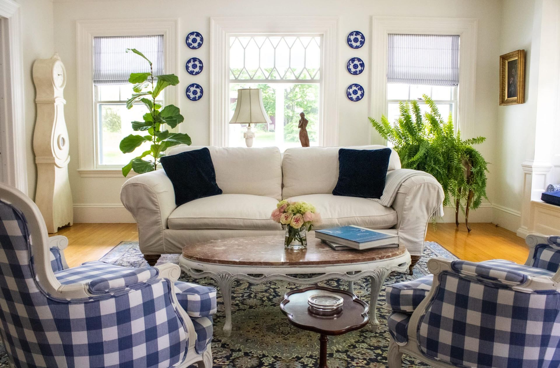 A living room with a couch , chairs , and a coffee table.